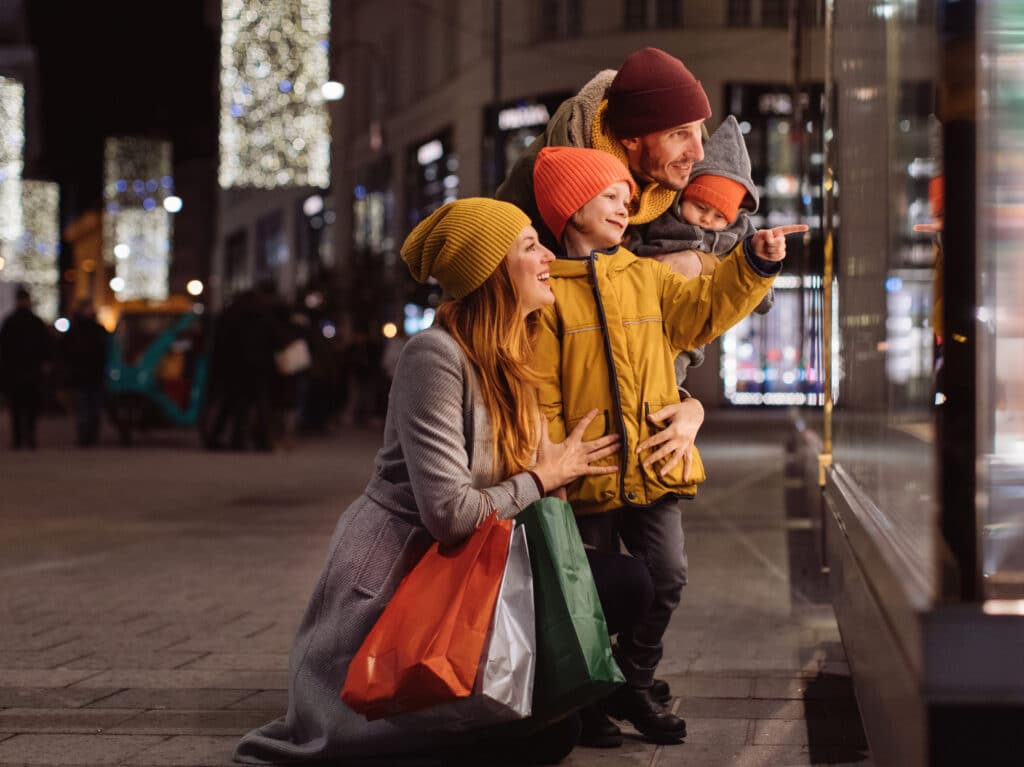 Family with two kids in front of the store window